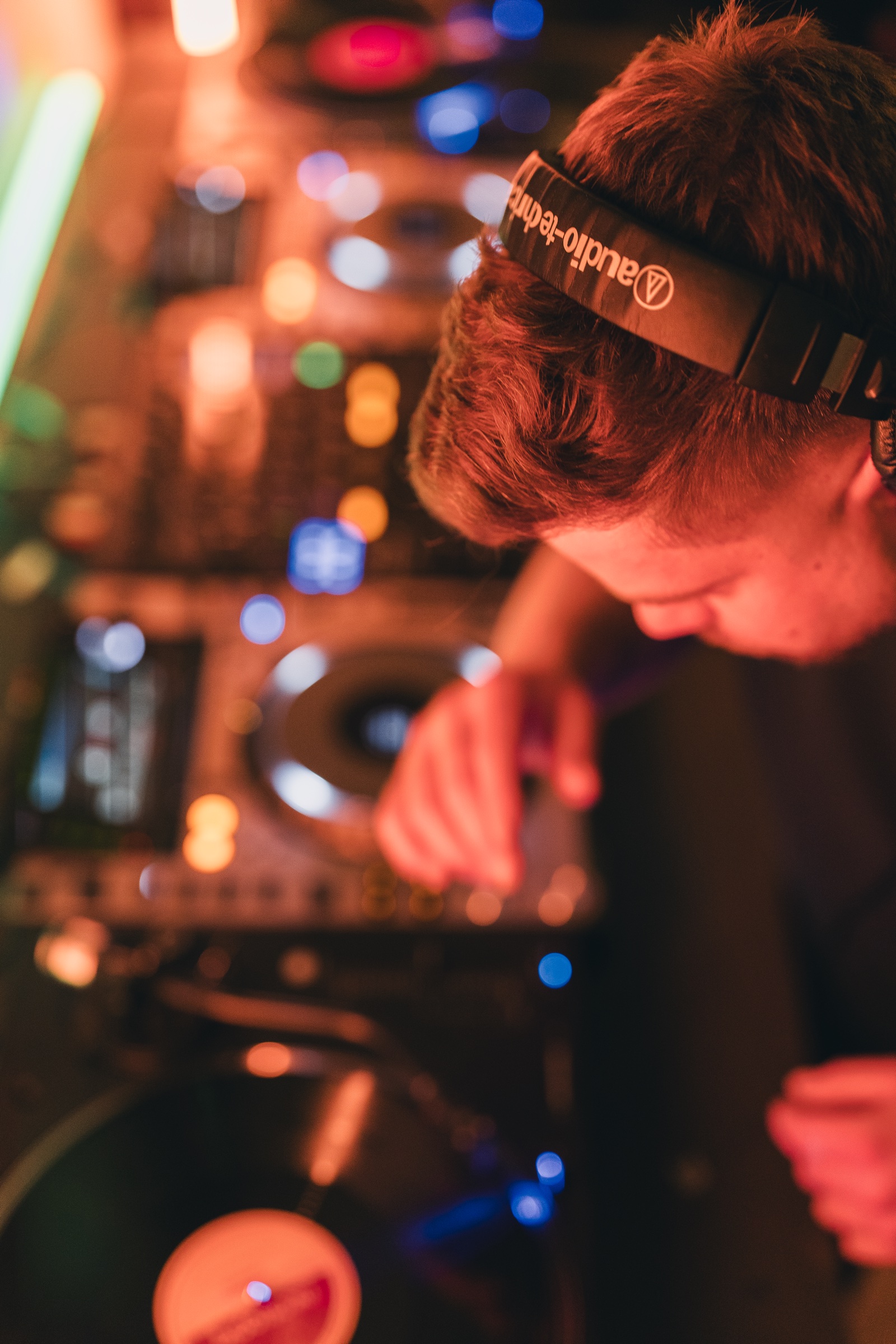 SIXLA mixing live set with headphones on the decks